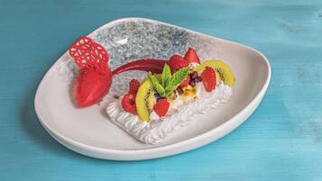 A dessert on a white plate with a blue background.