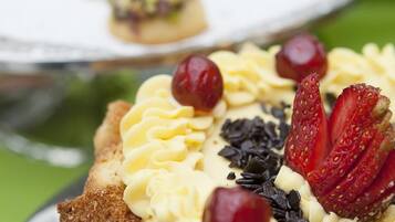 A dessert plate with a pastry topped with cream and berries.