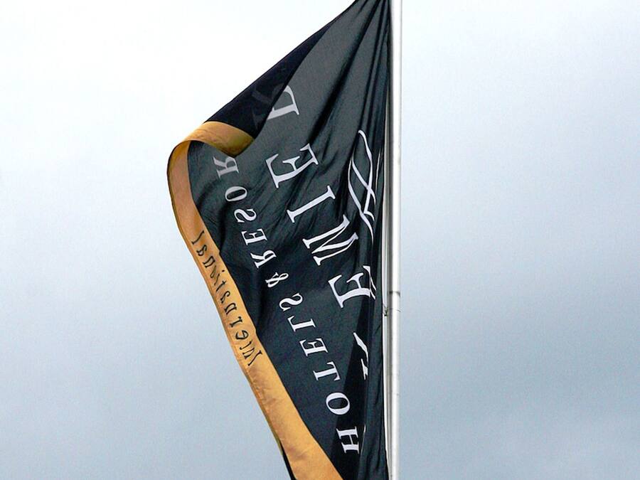A flag with the text "HOTEL" and "HOTEL GROUP" on a flagpole.