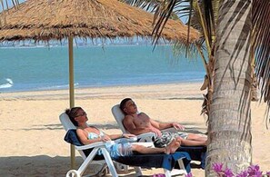 On the beach, white sand - Cape Point Hotel (Bakau)