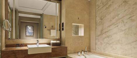 A modern bathroom with a large mirror, two sinks, a bathtub, and a towel rack.