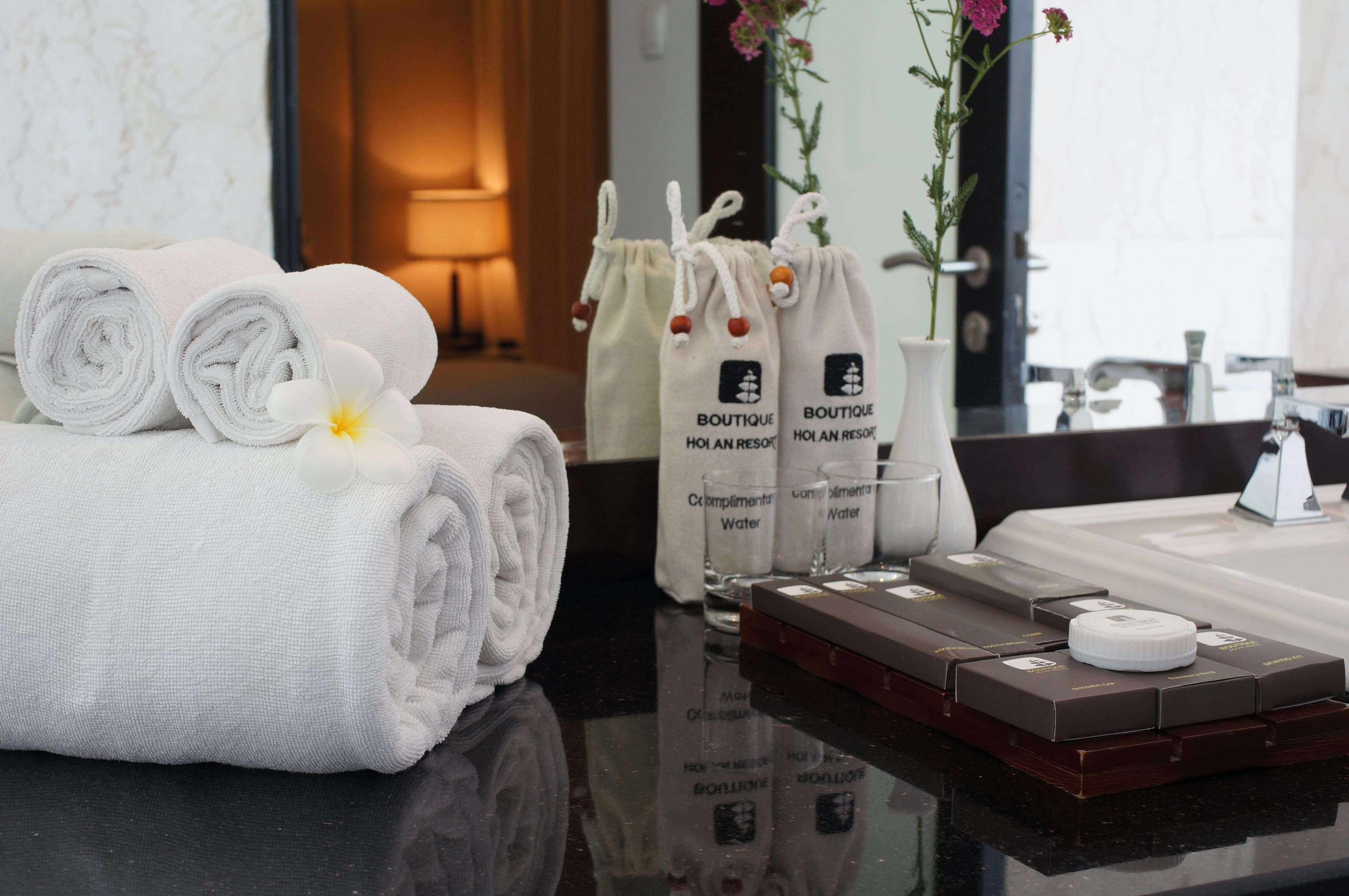 designer toiletries, hair dryer, bathrobes, slippers