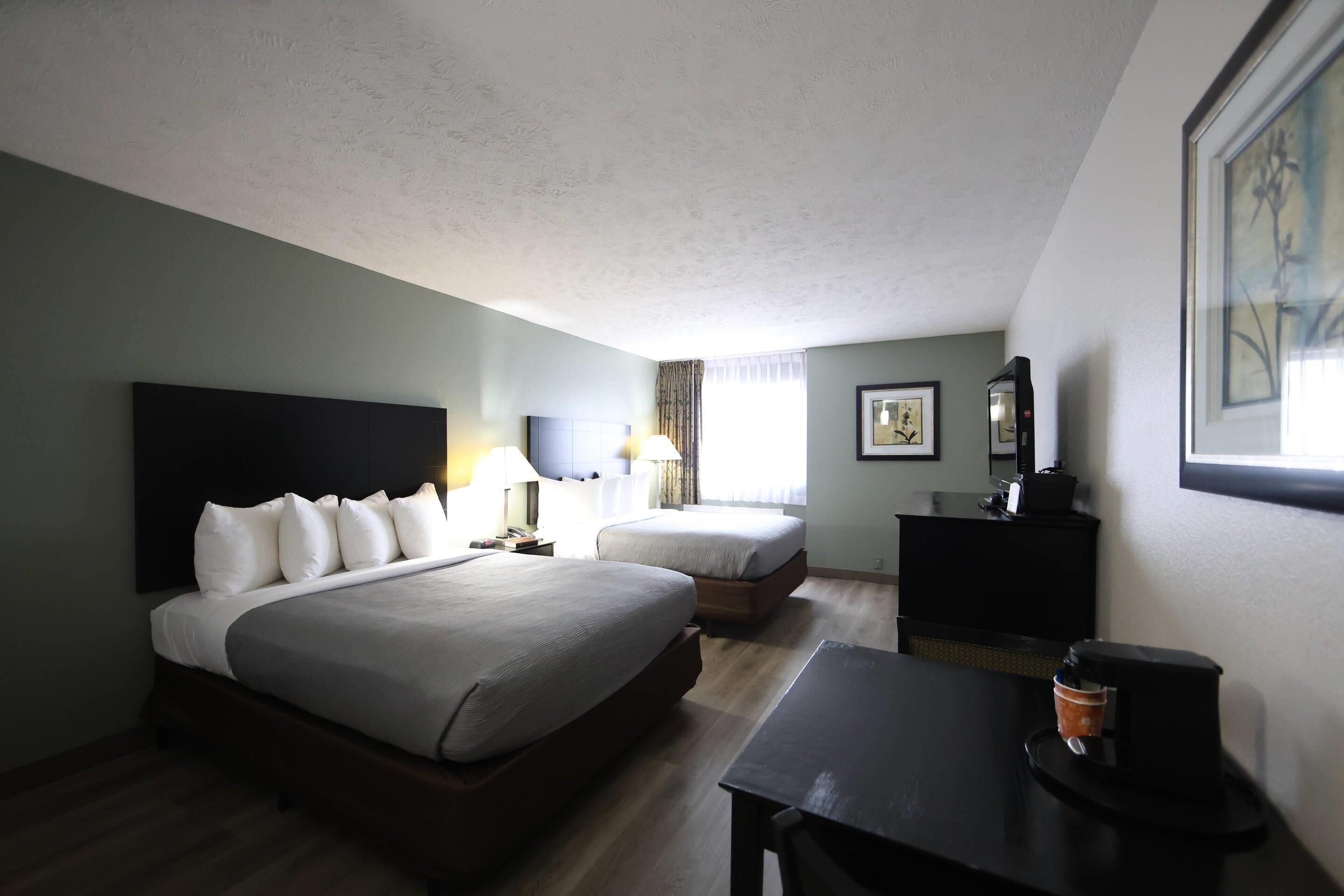 Standard Room, 2 Queen Beds, Non Smoking | Individually decorated, desk, laptop workspace, blackout drapes