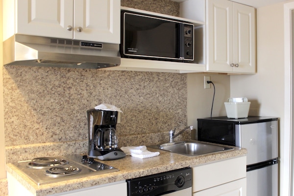 One Bedroom Suite with Living Room | Private kitchen | Mini-fridge, microwave, stovetop, dishwasher