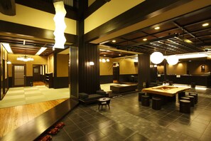 A modern hotel lobby with a checkered floor, seating areas, and a central wooden table. - Hida Hanasatonoyu Takayama Ouan (Takayama)