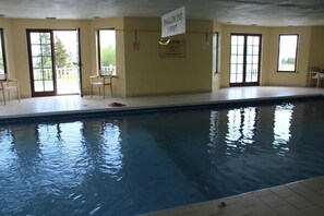 An indoor swimming pool with a shallow end marked 3 feet.