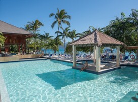 Una piscina al aire libre, sillones reclinables de piscina