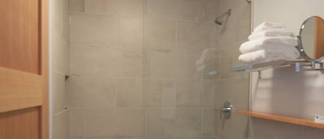 A bathroom with a shower, toilet, and a sink.
