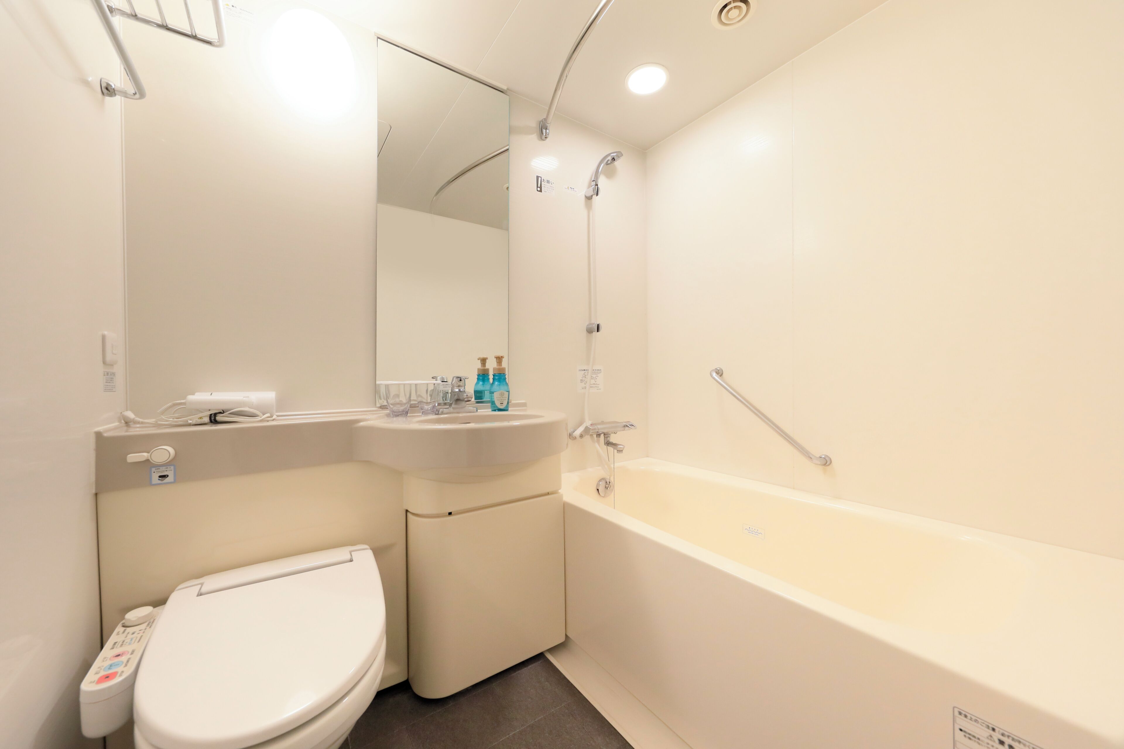A modern bathroom with a toilet, sink, and bathtub.