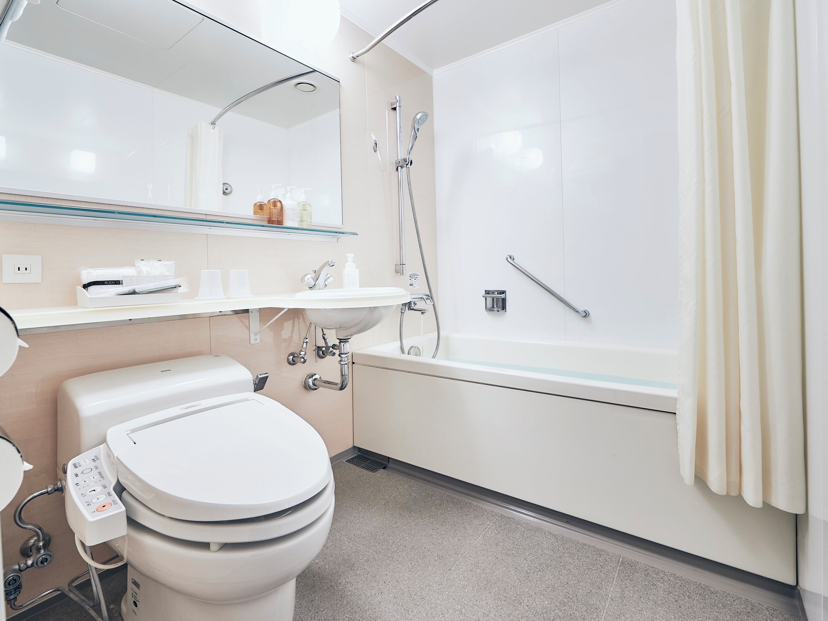 designer toiletries, hair dryer, slippers, bidet