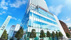 A modern high-rise building with a glass facade, a prominent 'LOFT' sign, and a clear blue sky in the background. - Lotte City Hotel Kinshicho (Tokyo)