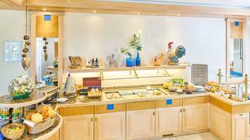 A well-equipped kitchen with a buffet setup, including various food items and decorative elements.