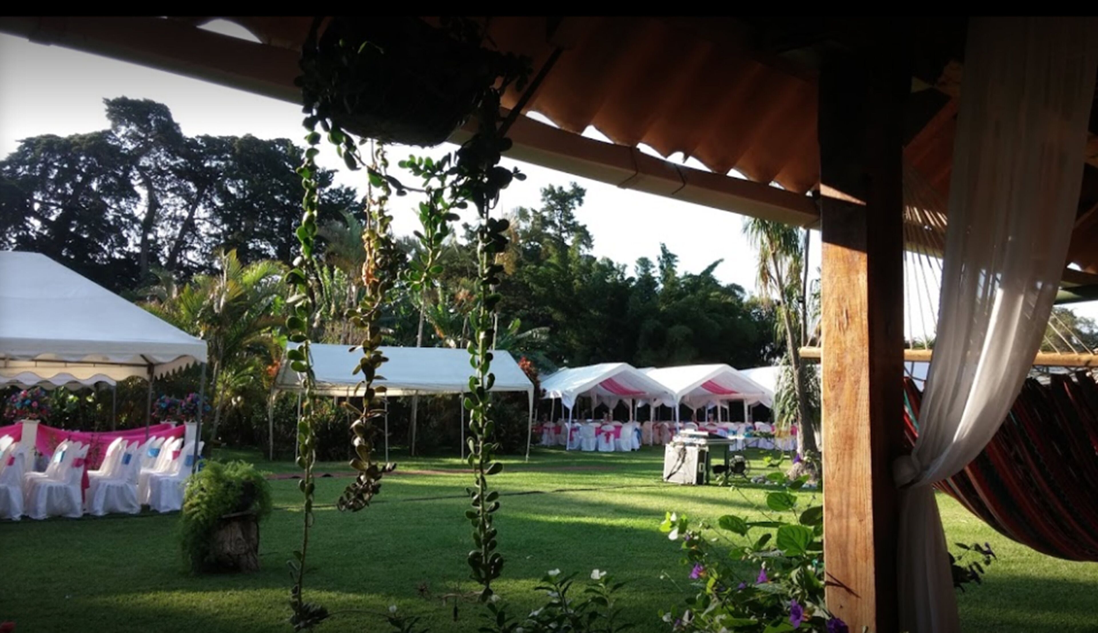 An outdoor event space with white tents and tables set up for an event.
