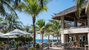 A resort with outdoor seating, a pool, and a view of the ocean. - Sailing Club Resort Mui Ne (Mui Ne)