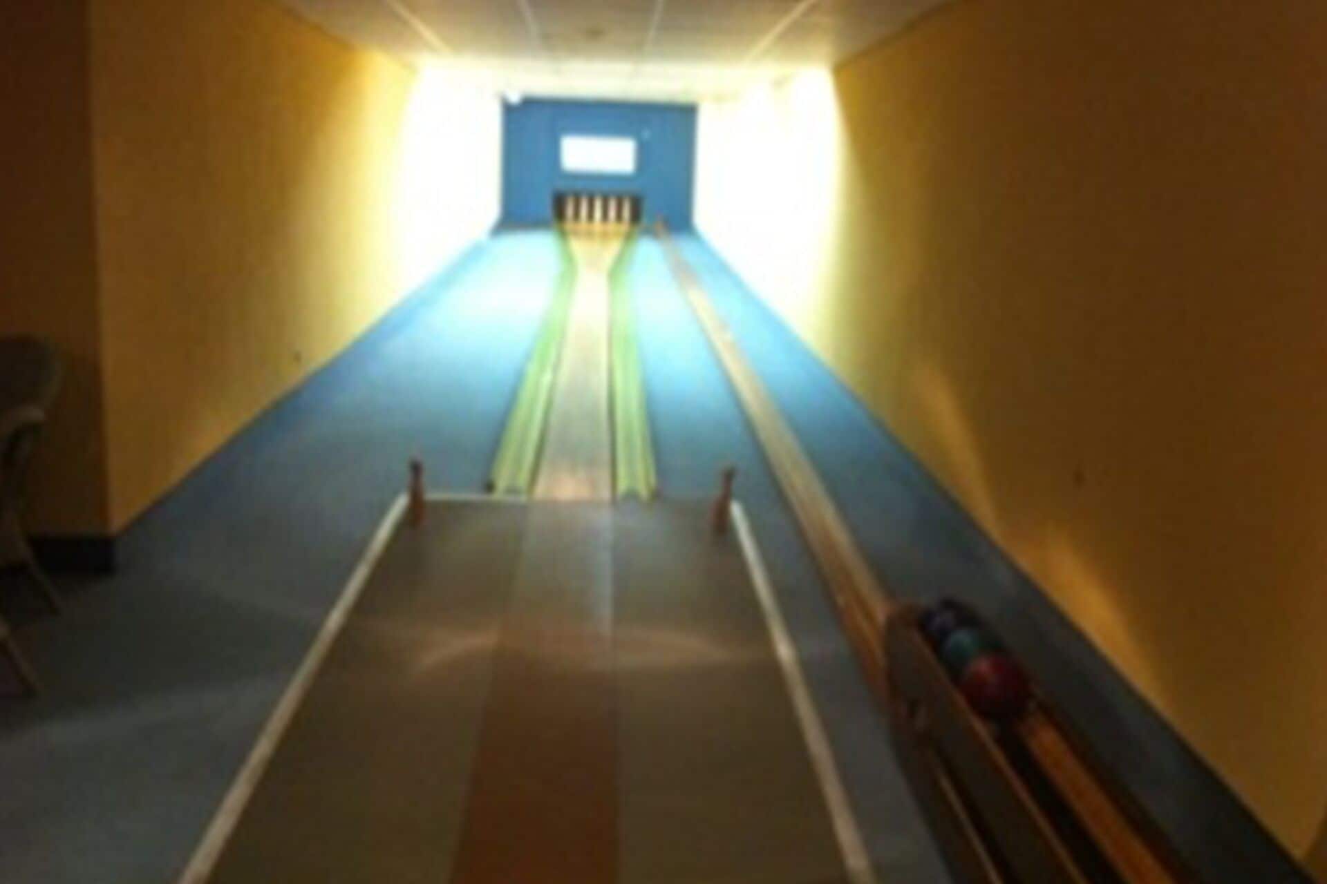 A bowling alley with lanes and pins.