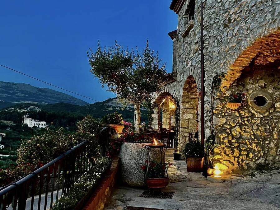 A stone building with a stone staircase leading to a terrace.