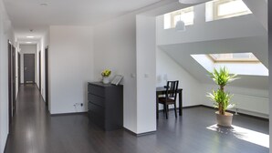 A spacious room with a skylight, a desk, a chair, and a potted plant. - 1. Republic Hotel (Prague)