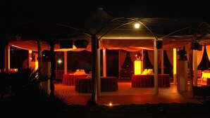 An outdoor dining area with tables and chairs under a covered structure. - Agriturismo Al Parco (Lecce)