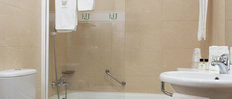 Un baño con inodoro, ducha y lavamanos.