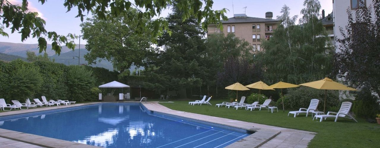 Una piscina cubierta, una piscina al aire libre, tumbonas