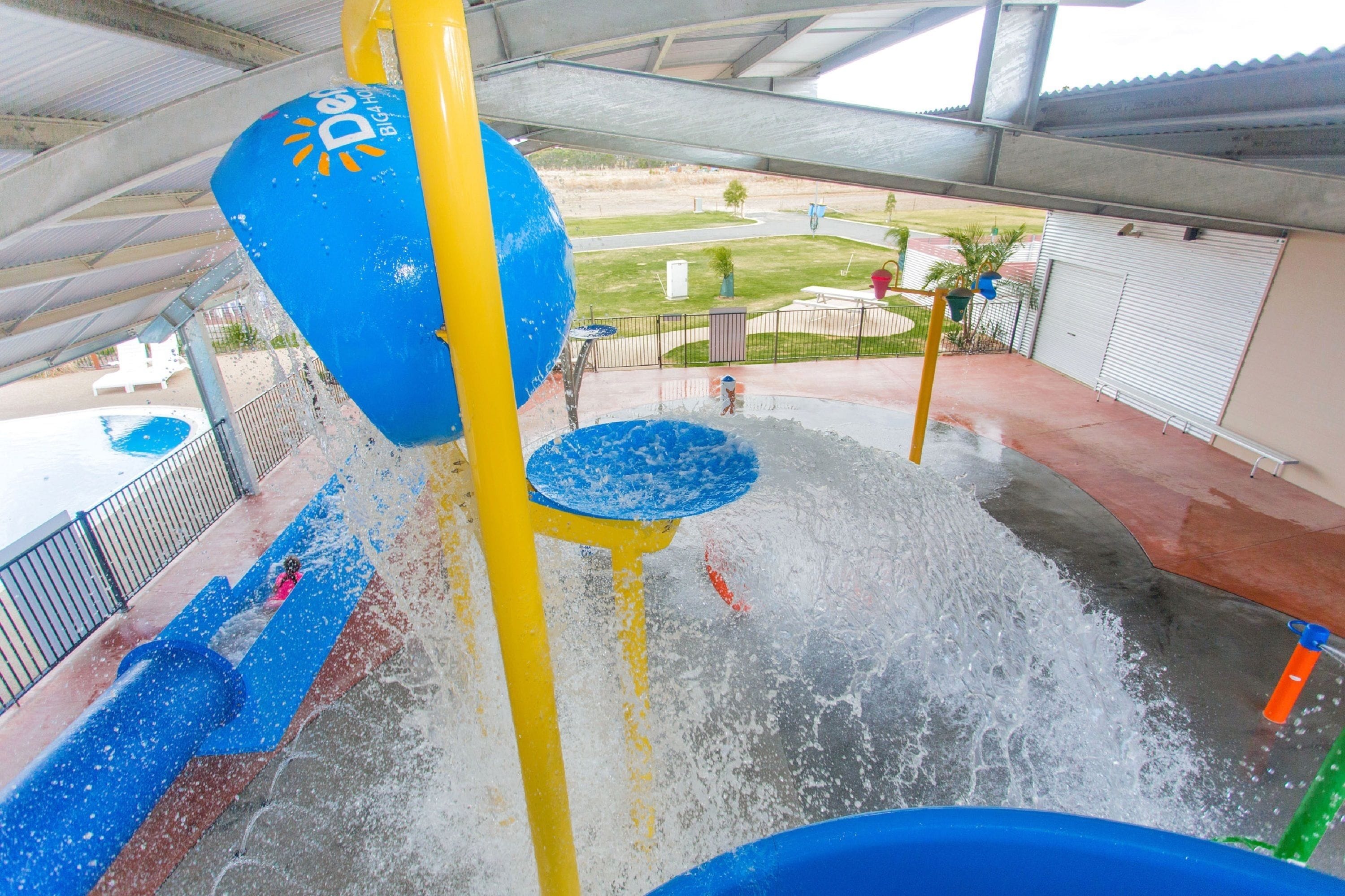 Un parque acuático con un tobogán de agua y una piscina.