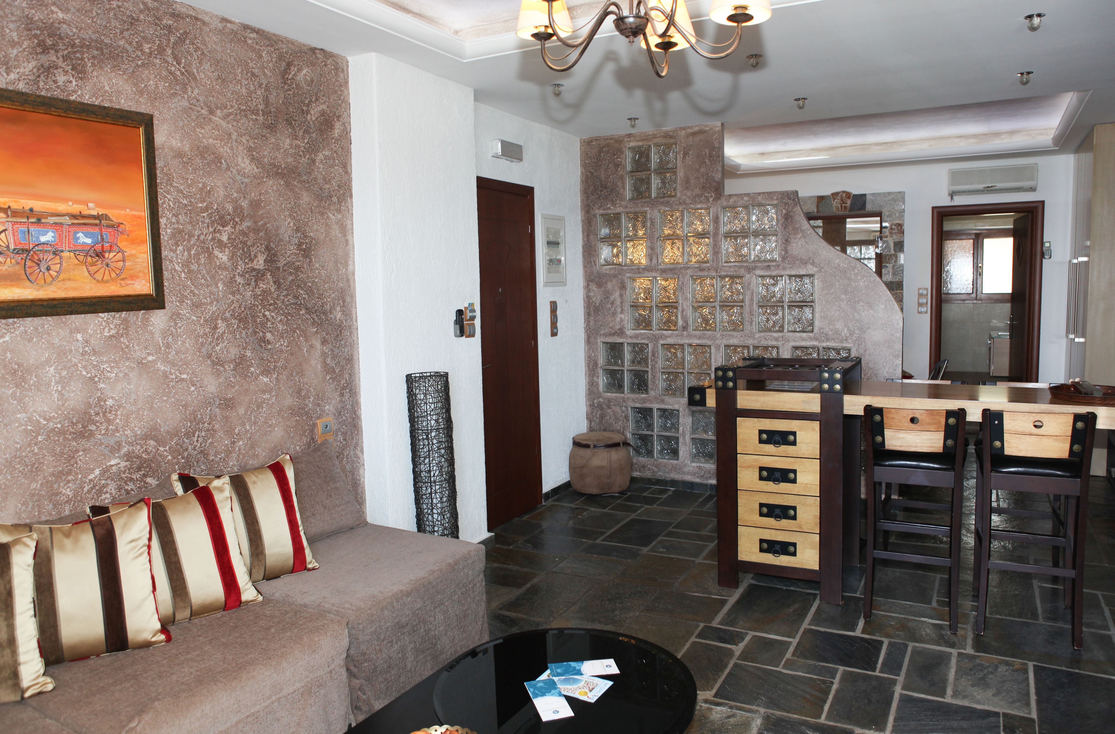 A cozy living area with a sofa, a coffee table, and a fireplace.