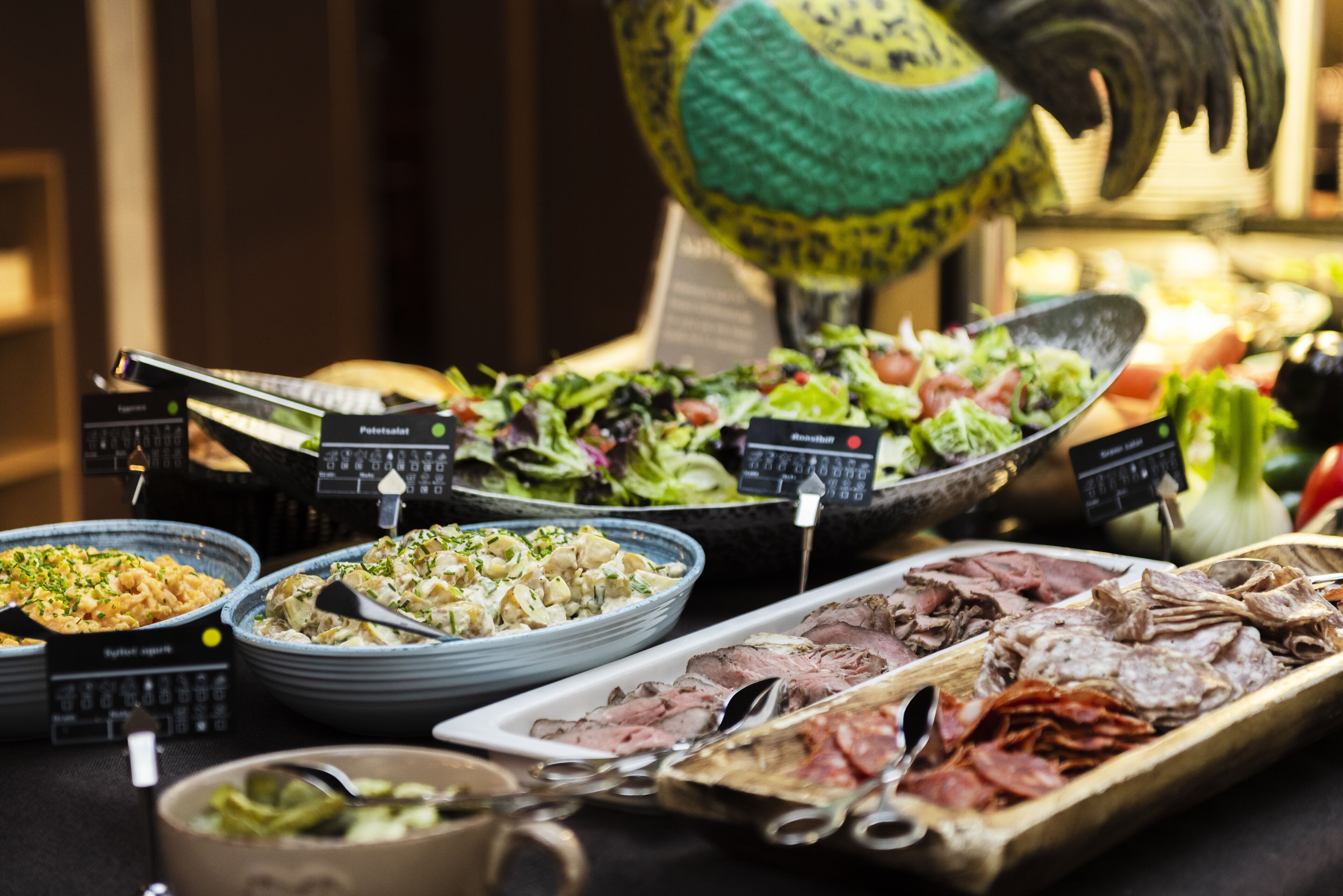 A buffet with various dishes including pasta, salads, and meats.