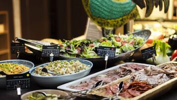 A buffet with various dishes including pasta, salads, and meats.