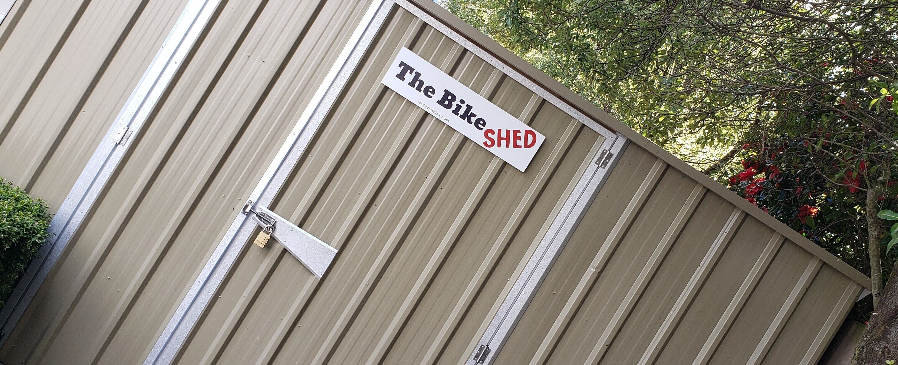 A corrugated metal building with a sign that reads "The Bike Shed."