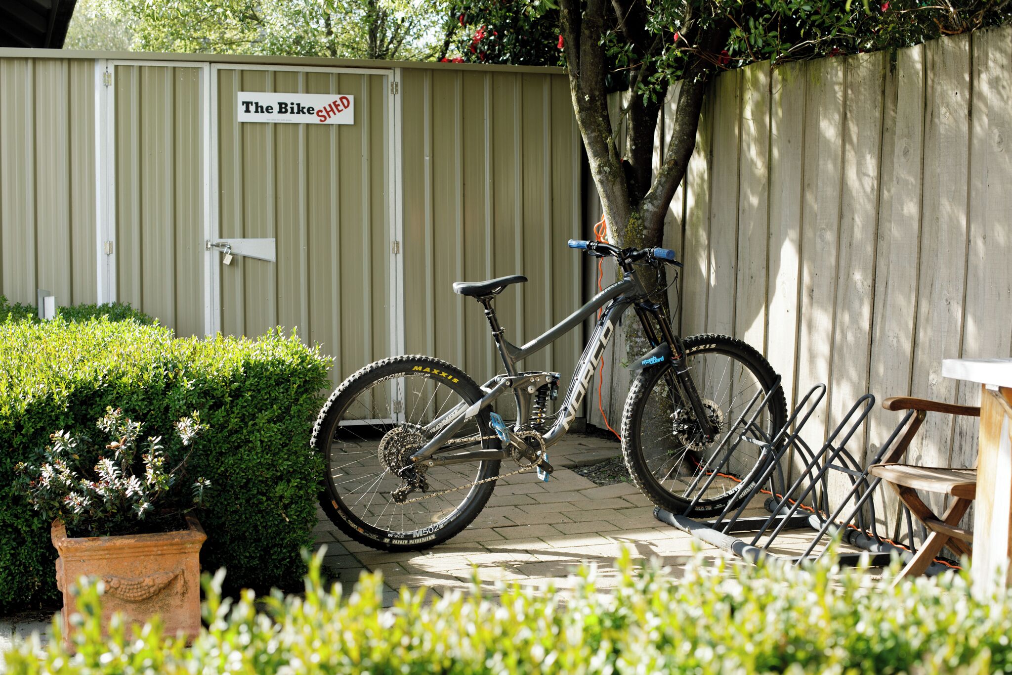 A bicycle parked in front of a shed labeled "The Bike Shed."
