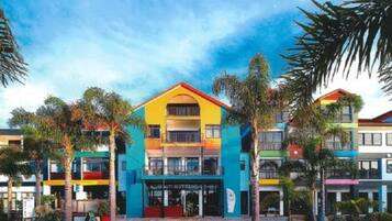 A multi-story hotel with a prominent entrance and balconies.
