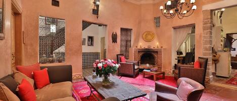 A cozy lounge area with sofas, a coffee table, and a fireplace.