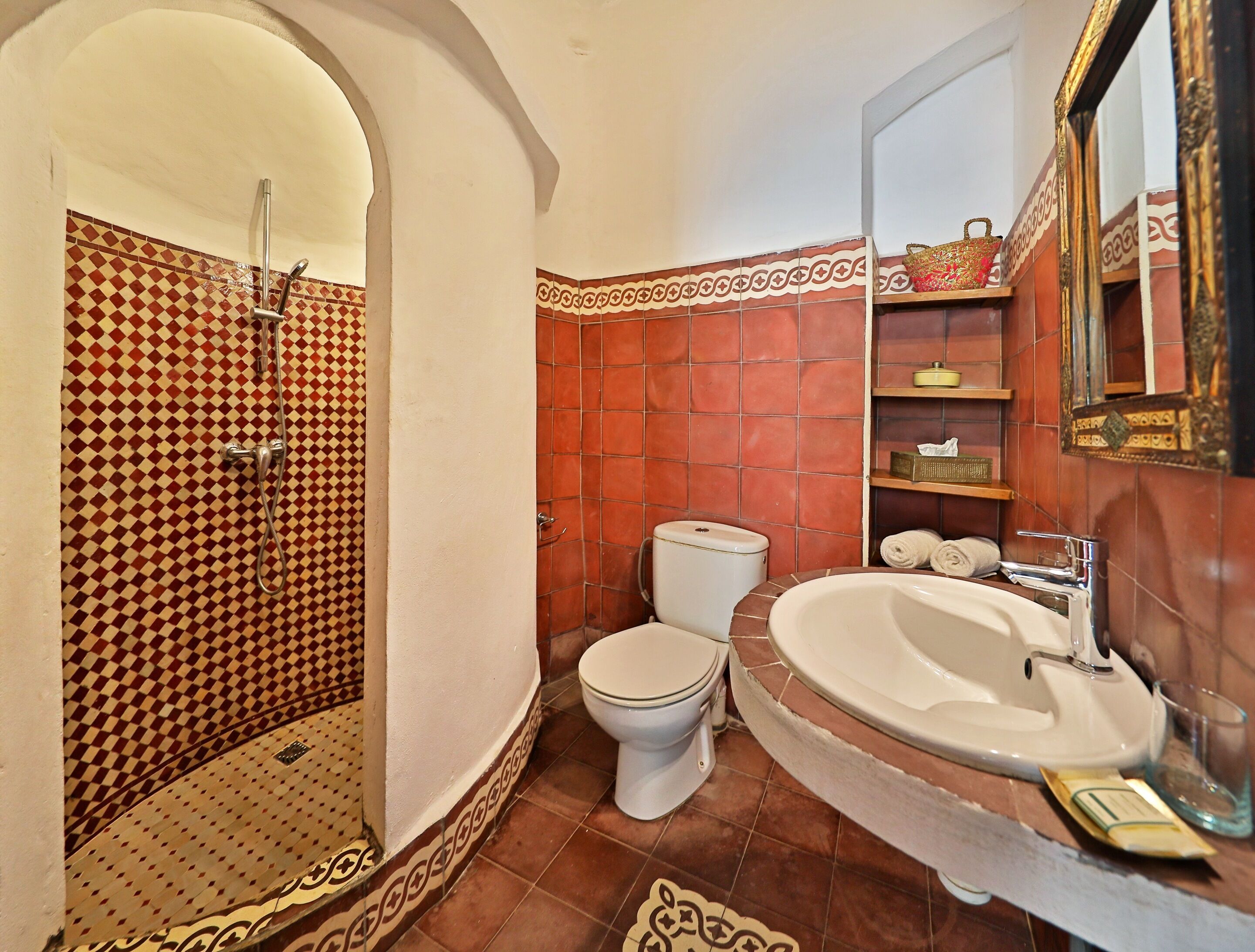 A bathroom with a shower, toilet, and sink.