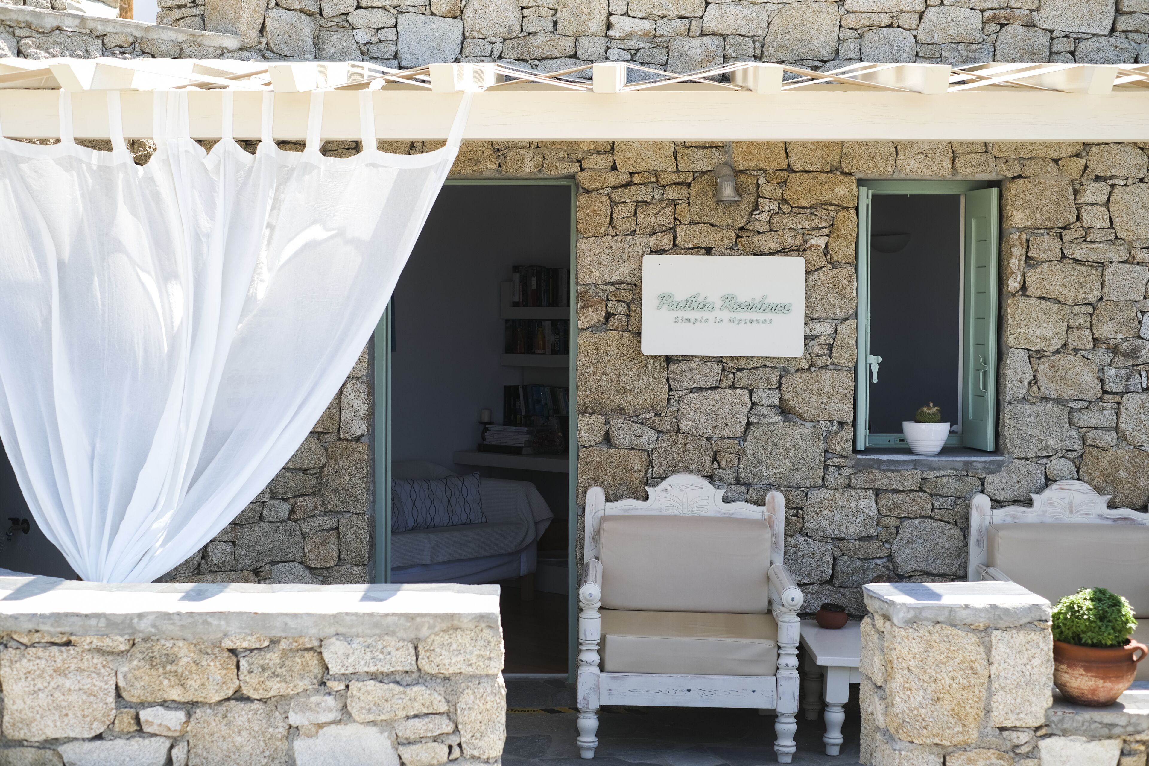 A stone building with a sign reading "Pondis, Rozalina" and a bed visible inside.