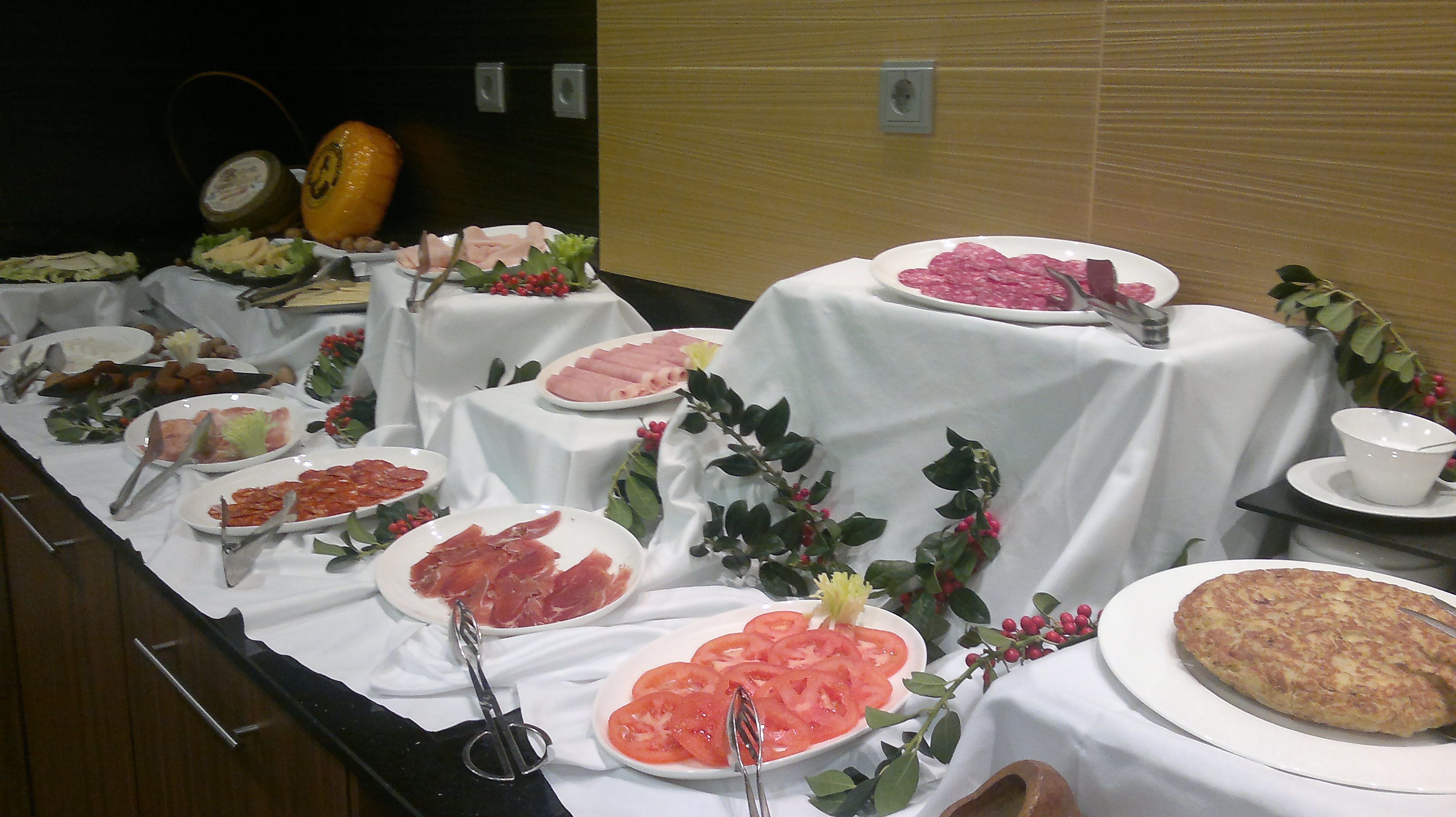 A buffet with various food items and utensils.