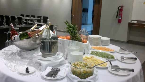 A buffet table with various food items, a champagne bucket, and a fire extinguisher in the background. - Hotel Ciudad de Ponferrada, Ascend Hotel Collection (Ponferrada)