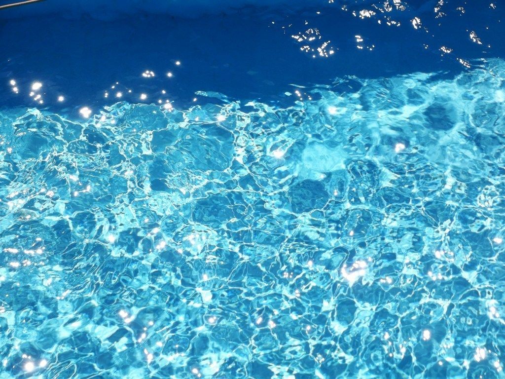 A pool with clear blue water and visible ripples.