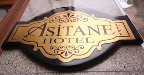A sign for Asitane Hotel with a decorative design and the words "Asitane Hotel" and "Life" on it.