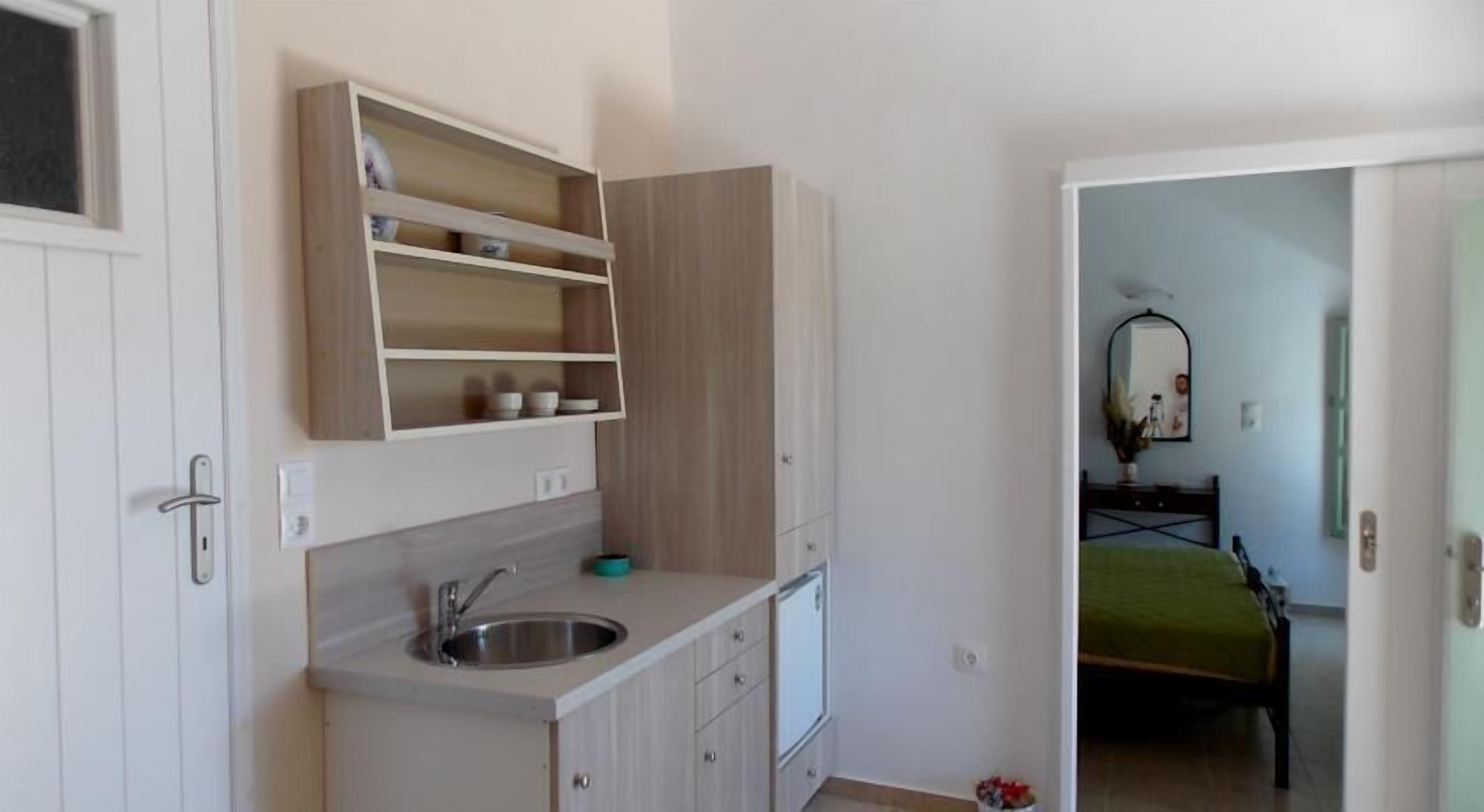 A compact kitchen with a sink, cabinets, and a countertop.
