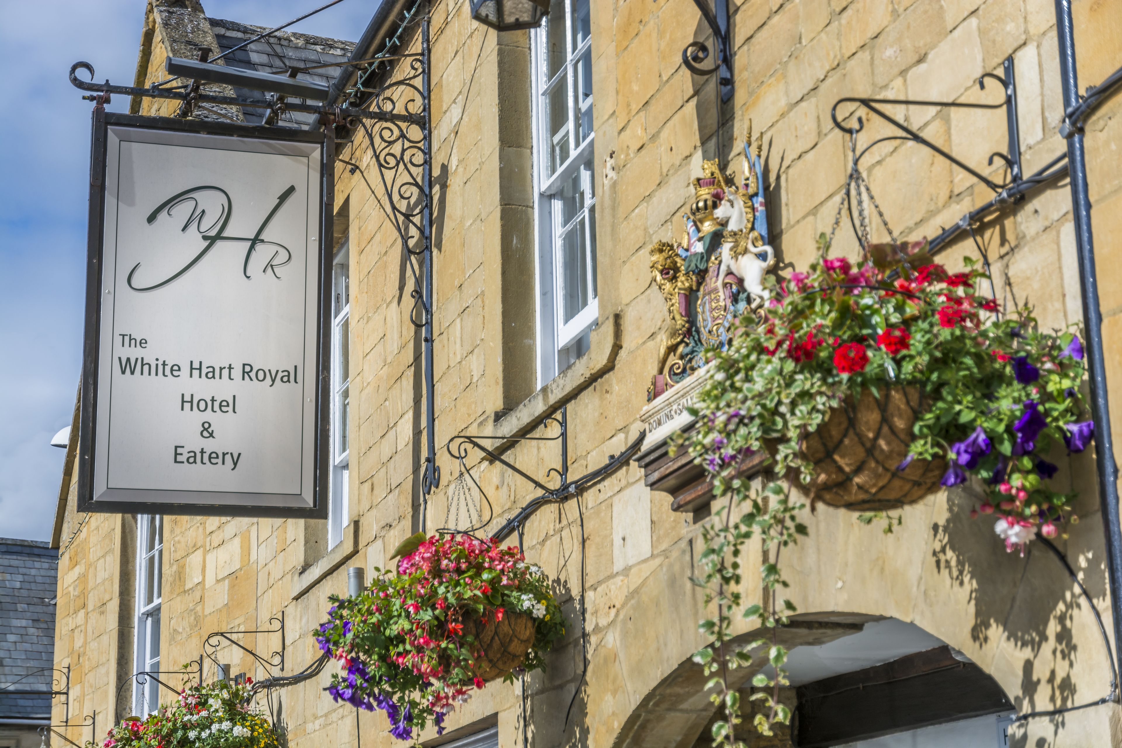 A building with a sign for The White Hart Royal Hotel & Eatery.