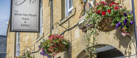 A building with a sign for The White Hart Royal Hotel & Eatery.