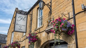 A historic building with a sign for "The White Hart Royal Hotel & Eatery." - The White Hart Royal Hotel, Moreton-in-Marsh (Moreton-in-Marsh)