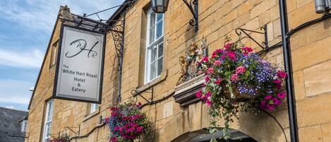 A historic building with a sign for "The White Hart Royal Hotel & Eatery."