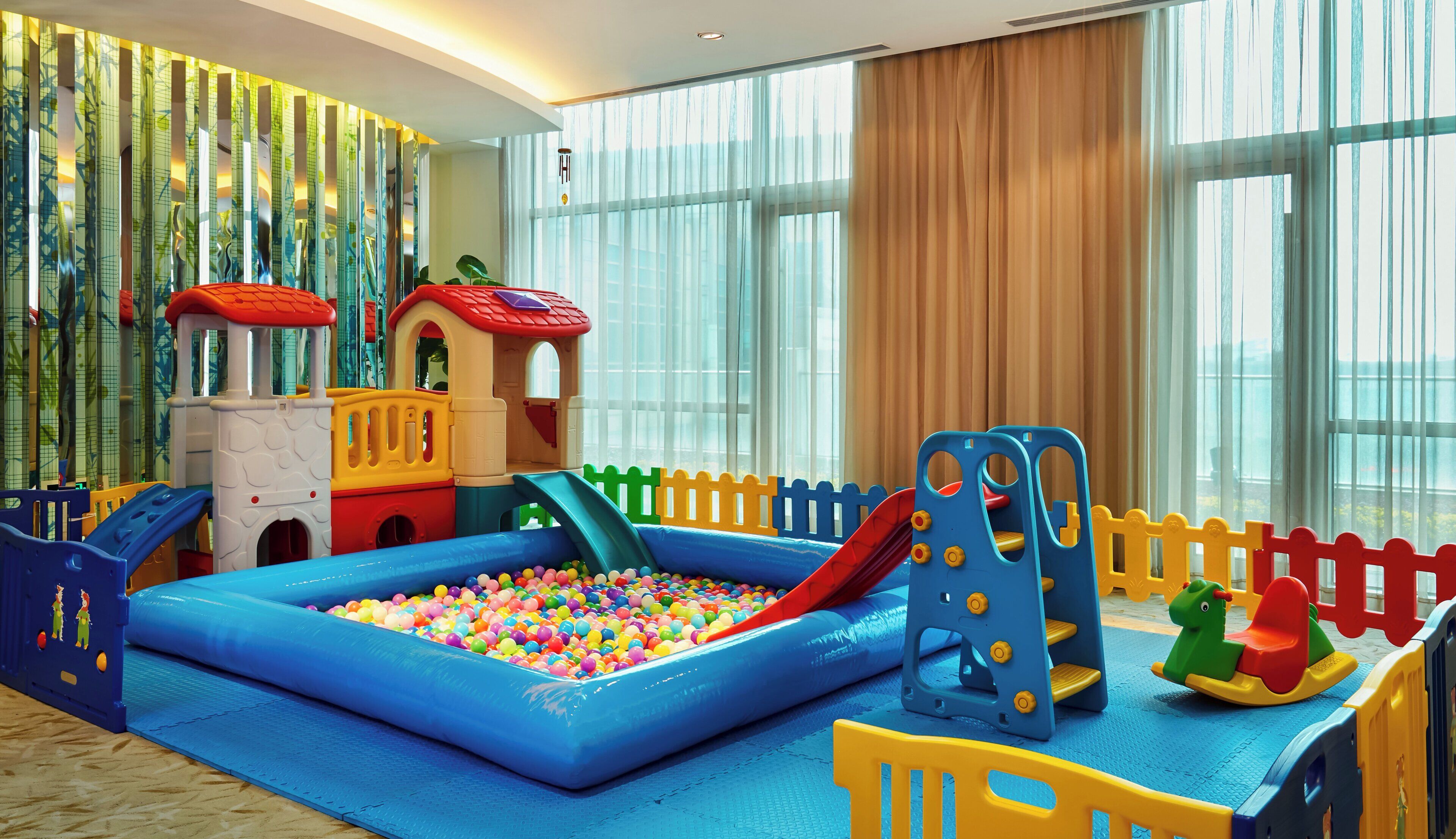 A play area with a ball pit, slides, and a climbing structure.