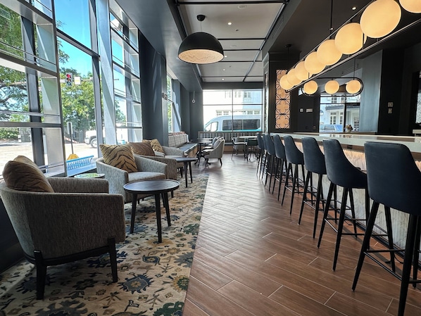 A modern bar area with seating and a bar counter. - Hotel Indigo Baton Rouge Downtown by IHG (Baton Rouge)