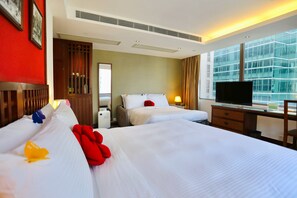 A hotel room with two beds, a TV, a desk, and a large window with a view of a building. - Butterfly on Wellington, Central (Hong Kong)