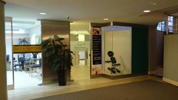 An indoor space with a reception area, a potted plant, and a sign for 'Silvia Gehring'.