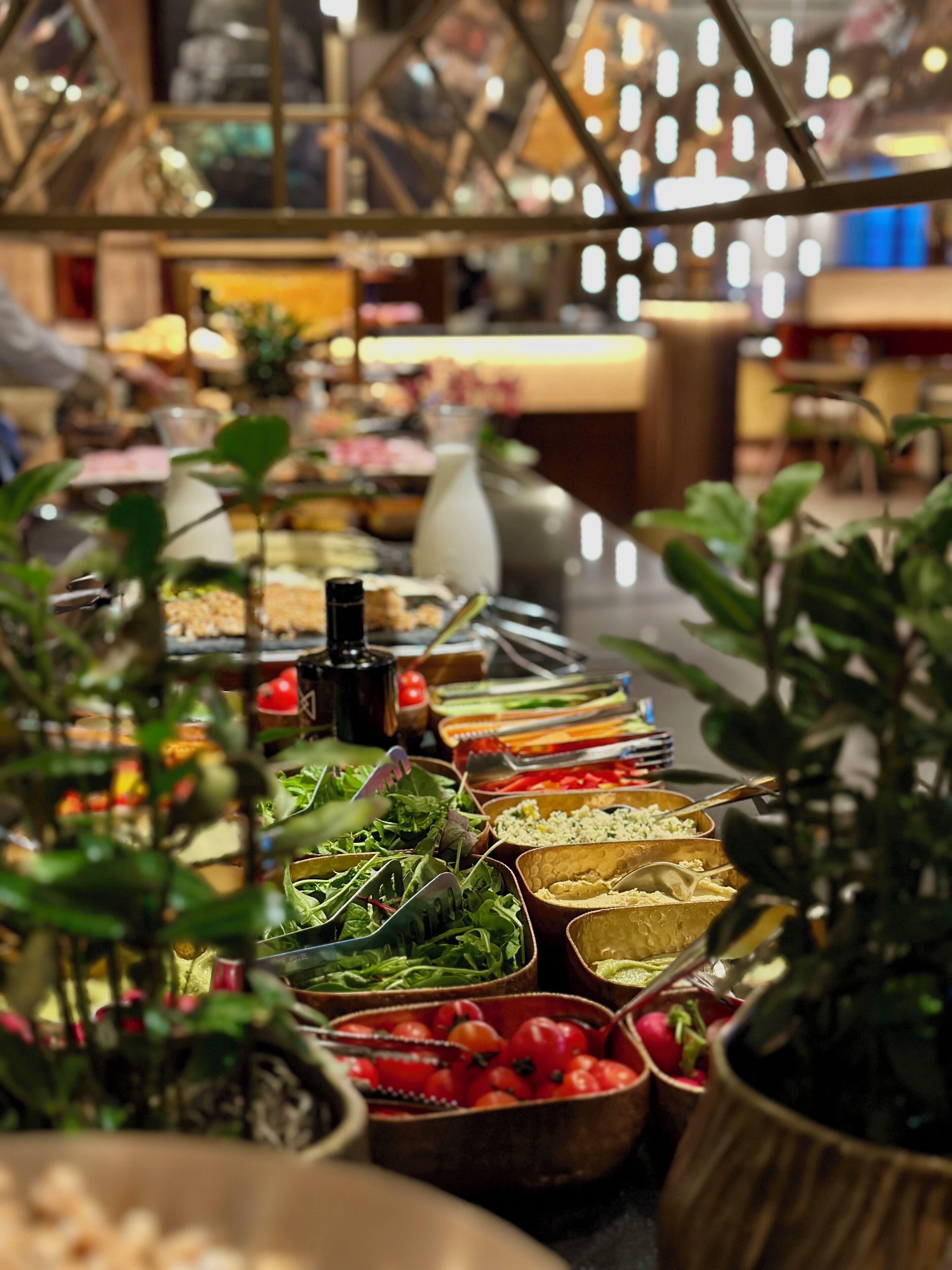 A buffet with various food items and utensils.