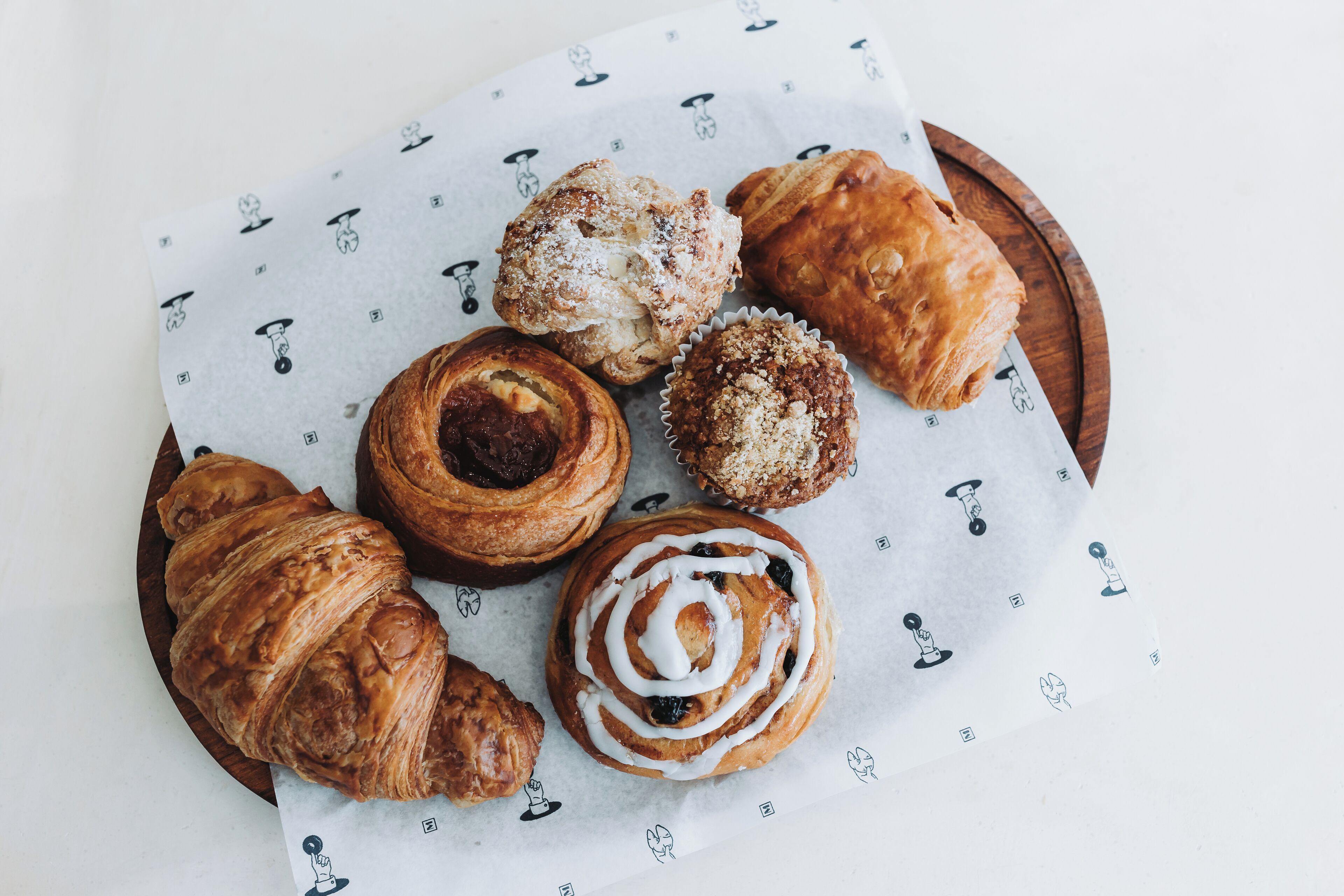 A variety of pastries on a wooden tray.
