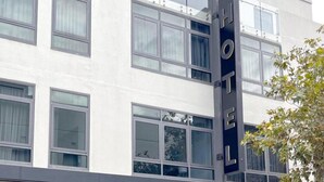 A modern hotel building with multiple windows and a prominent 'HOTEL' sign. - New Haus Managed by Hougoumont (Fremantle)